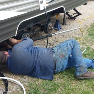 Bruce from Lippert installing new axle on site at the 2014 Crossroads Rally