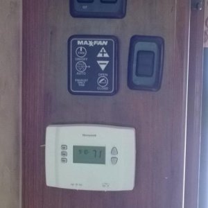 Residential programmable thermostat with high/low fan switch and switch for led step lights.