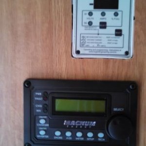 These are my battery monitor on top and my inverter/charger remote on the bottom.  I decided to locate these in the wall of my entertainment center, t