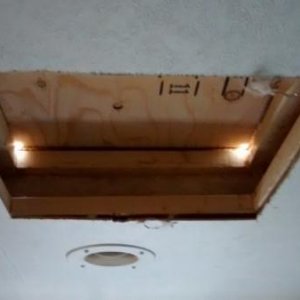 Cut hole in bedroom ceiling and drilled corner holes through roof.