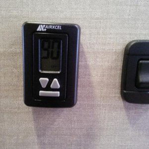 New thermostat design. Bottom button lights up large display.