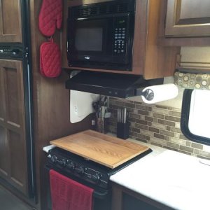 In this photo you can see we use Command Hooks for the pot holders and as storage for the sink covers along the side wall next to the stove. I would l