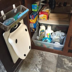 Mounted Command Hooks under the kitchen sink cabinet door to hang my cutting boards and storage basket for cleaning items. Also, I use a magazine rack