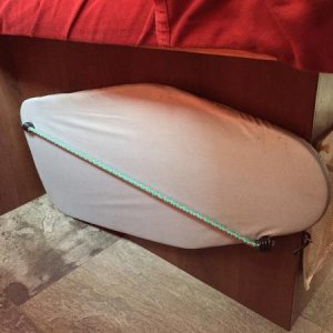 Using 2 eye hooks and a bungee cord I was able to store my tabletop ironing board under the bed.