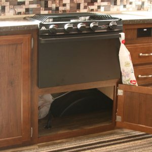 I removed the plywood divider in the cupboard under the oven to open more usable storage space.