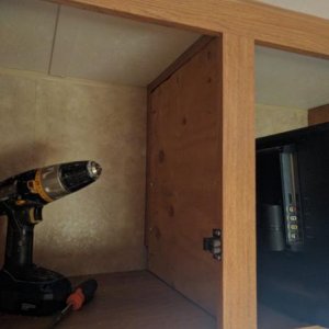 Plywood installed in cabinet (will behind closed door) to reinforce cabinet partition for TV mount.