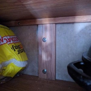 Back of TV mount in cabinet above sink, oak plank used as re-enforcement plate.