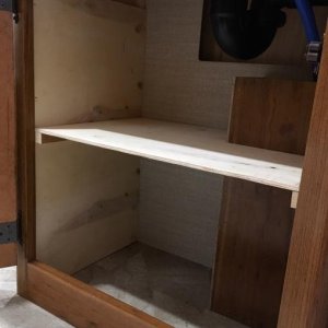 Opened up area under bathroom sink and added a shelf.