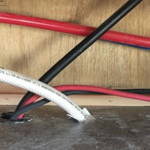 Inverter wiring goes behind panel and passes through hole for water heater gas line