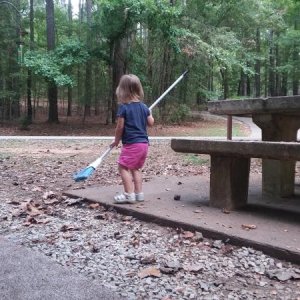 Helping to sweep camp site