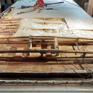 More sheathing removed from the front. Everything removed so far was wet and rotted. The ceiling paneling has dislodged from the trusses in the front 