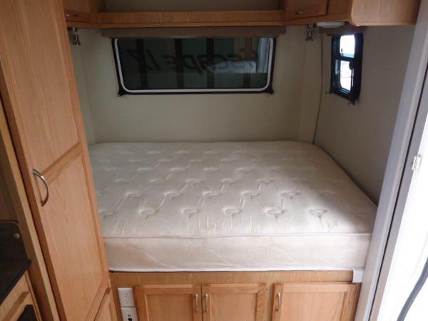 -8" queen mattress.   -
porta-potty cabinet is to the right below the bed.