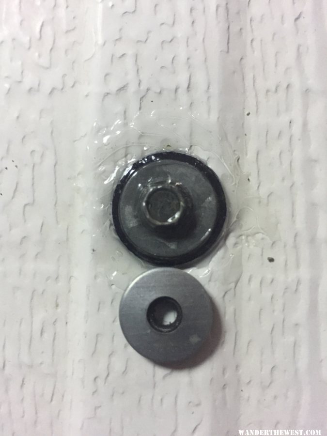 a little dome of urethane caulk, replacement bonded washers from Four Wheel