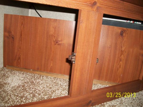 A panel in the TV Cabinet lower storage area is there to prevent items from going back where the wires and BBQ LP hose is located.