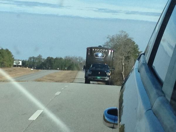 A shot from the Dodge Journey looking back in the side view mirror at our Ram 1500 pulling the SF32RL.