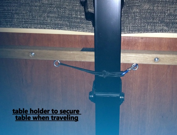 Added a small eye-bolt and latch to hold table in place while traveling.