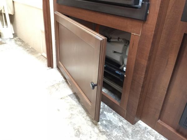 Added hinges and a door knob on the panel under the refrigerator for easier access.