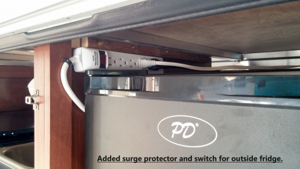 Added surge protector with on/off switch for outside fridge