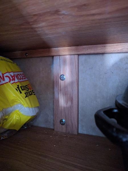 Back of TV mount in cabinet above sink, oak plank used as re-enforcement plate.