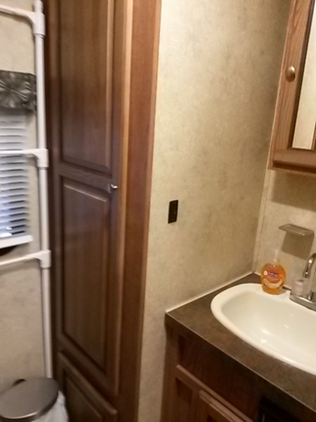 bath wardrobe cabinet and sink (water heater located in cabinet below wardrobe cabinet)