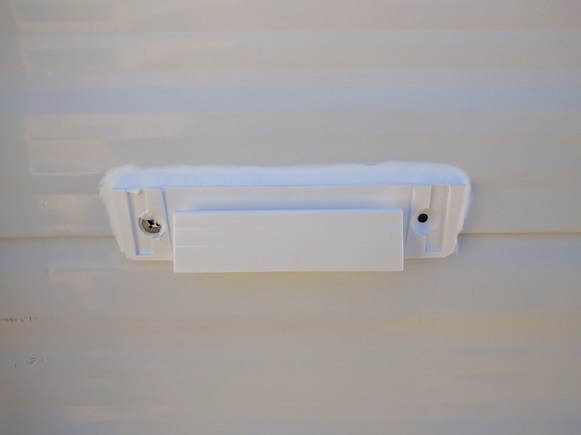 Bracket for removable motion sensing solar lights. This one was mounted with a stainless screw and 3M tape as the paneling was bowing out here and thi