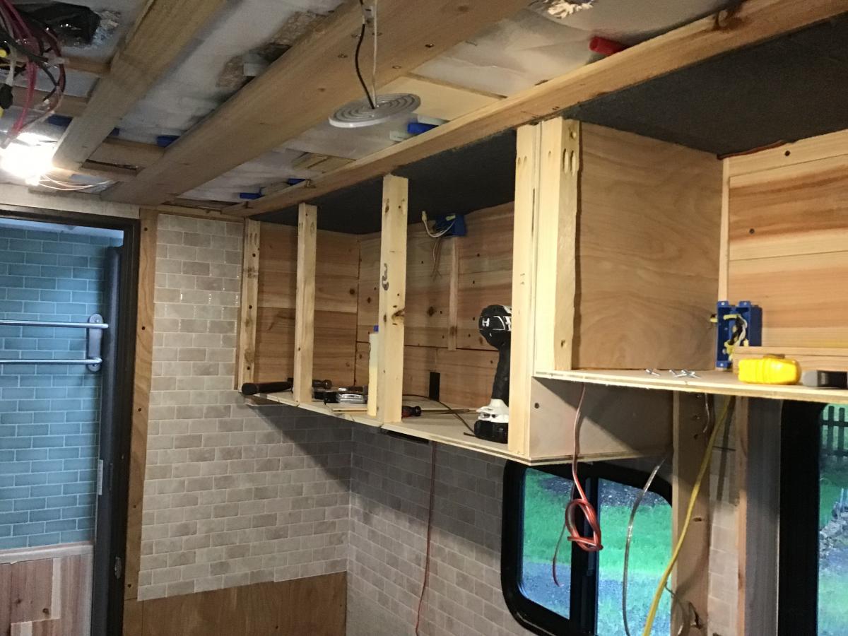 Building overhead kitchen cabinets. No microwave here.