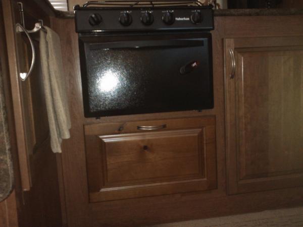 cabinet door to access space under stove