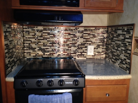 Completed stove top area. Although the surrounding trim pieces add a nice contrasting touch, it is SO hard to get the tiles lined up with each other a