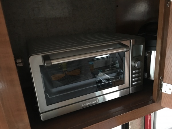 Convection oven fits perfectly next to our 3 qt Instant Pot in the cupboard above the dinette.  Door shuts without a problem, and stays latched.