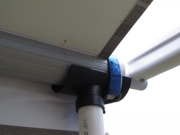 cradle and tie down strap for electric awning when extended