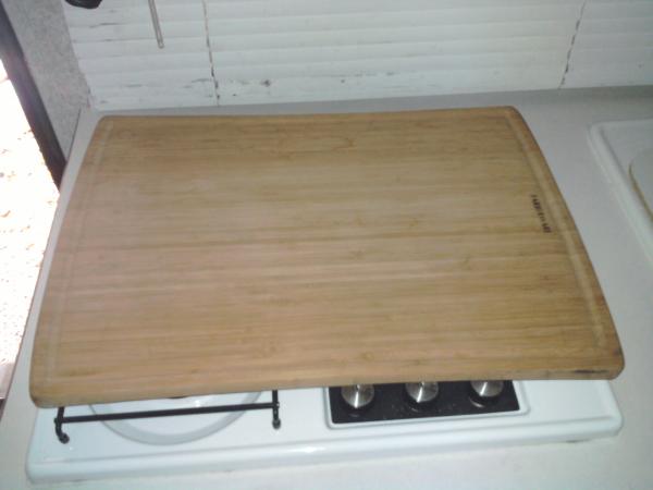 Cutting board. Shelf mat material holds it on during travel.