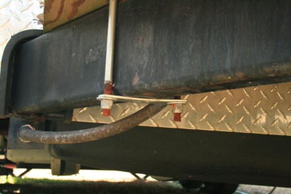 Flat plate from a "U" bolt with nylon lock nuts on the bolts.