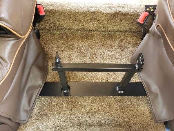 Front bracket with bolts hidden under chair skirts. When front seat bracket removed mounting tabs are completely hidden.