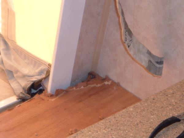 Front Shelf 3: road side.  This is view after removing moulding.  It shows water damaged to the mdf board.