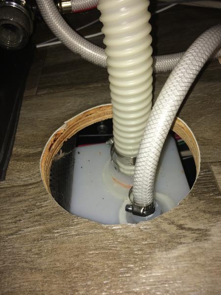 Gee, how do mice and cold drafts get in our rigs? Uh, massive holes in the floor like this under our kitchen sink, courtesy of the Jayco production li