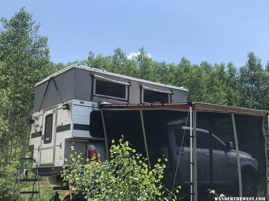 Granby camper popped up with awning and screen room