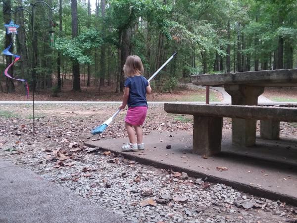 Helping to sweep camp site