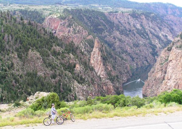 Highway 92 bike ride between Blue Mesa Dam and Pioneer Point Curecanti NRA> Curecanti Needle and Morrow Point Lake with the tour boat cutting wake.