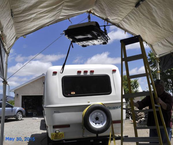 Hoisting up the air conditioner.