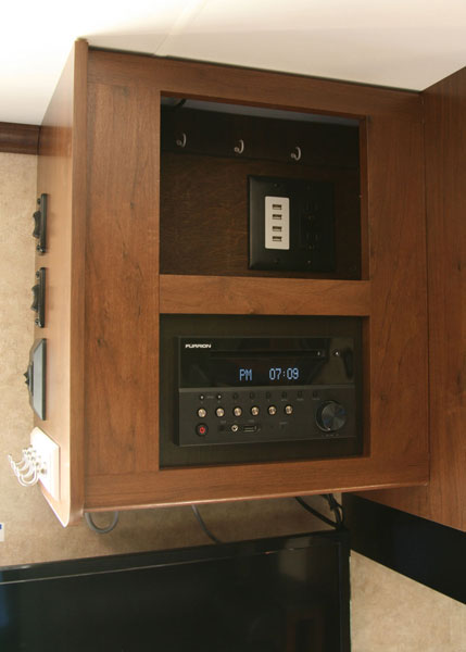 I created a charging station above the radio. The usable space behind the panel was easily modified with a duplex outlet and USB charge block.