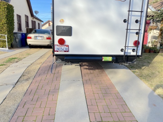 I got tired of crawling under the trailer to get the sewer hose out. So, I added a hose carrier on the back. It is much easier to access. So now I car