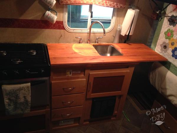 I made a larger counter that fits on top of the original counter. It's a little longer and has a cut out for one side of the sink, making the counter 