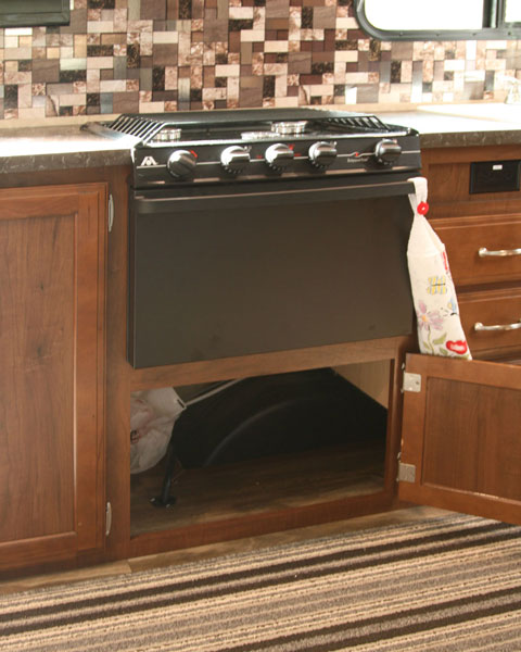 I removed the plywood divider in the cupboard under the oven to open more usable storage space.