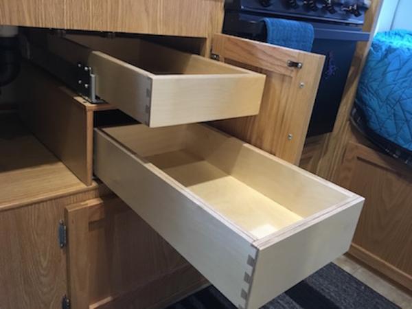 I wanted to have the oven in my 19, but it lacked silverware drawers, so I added two drawers under the sink.  Came out great, they are full extension 