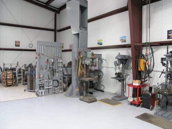 In this picture, the drill press in the middle is a variable speed Powermatic 20" awaiting restoration, slightly to the right is a 50 hydraulic press,