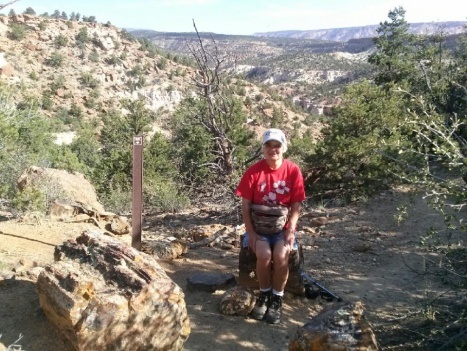 Joyce on petrified wood in escalante st prk, UT