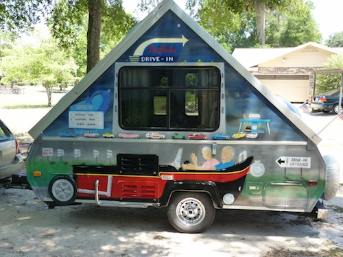 Left side of trailer faces traffic. Front wheel of street rod is 16" pizza pan. Side pipe is modified handrail salvaged from handicapped restroom. Beh