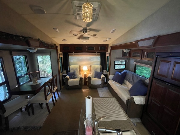 Living Area:
We removed all stock window valances and wallpaper border, updated the pendant light shades, unbolted the table from the floor and turned