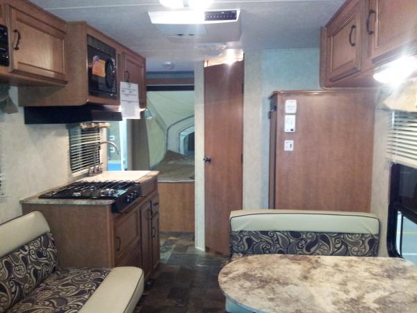 Looking aft from front queen bed.
From left to right:
Fold down couch, 3 burner stove (microwave overhead), rear queen bed, bathroom, Fridge w/ freeze