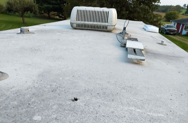 Looking at the roof before washing it late September. I see a perfectly round 3/4" hole about 3 feet from the rear of the trailer. Looks like someone 